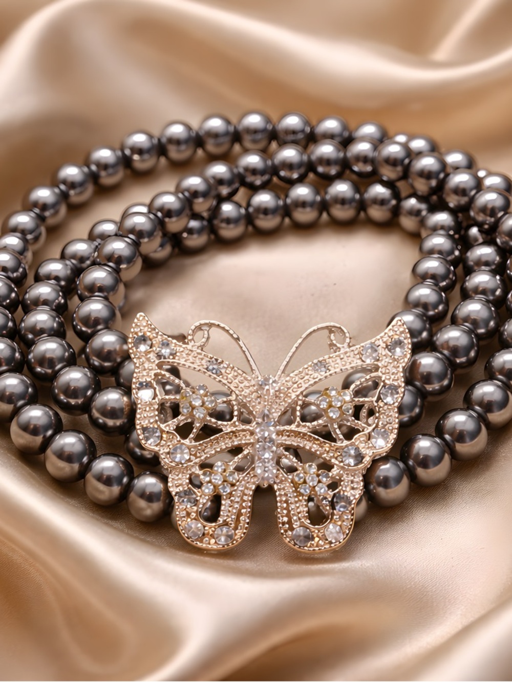 Nina Ricci Gunmetal Pearl Bracelet with Gold Crystal Butterfly Clasp